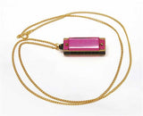 5-hole pink harmonica with necklace.
